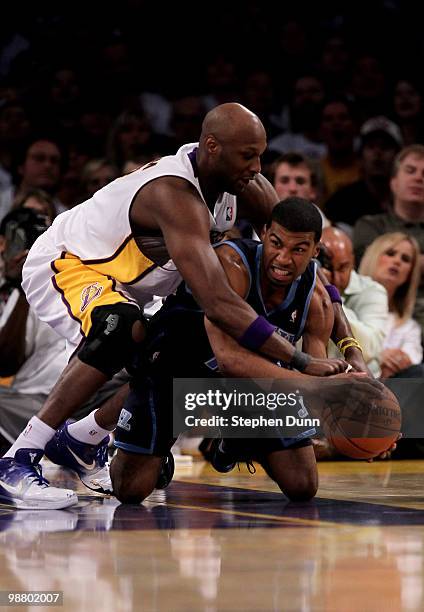 Ronnie Price of the Utah Jazz goes to the floor to fight for a loose ball with Lamar Odom of the Los Angeles Lakers during Game One of the Western...