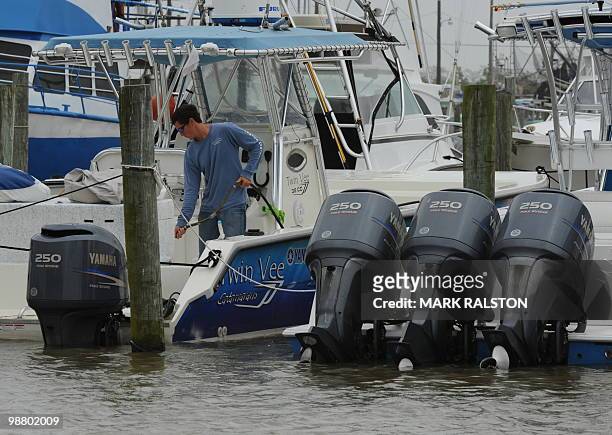 Charter boat operator cleans his boat at a Venice Marina after a commercial and recreational fishing ban was imposed on oil affected areas following...