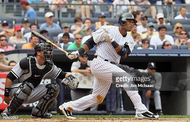 Robinson Cano of the New York Yankees follows through on his fifth inning three run home run against the Chicago White Sox on May 2, 2010 at Yankee...