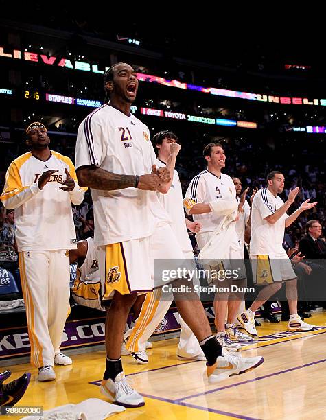 Josh Powell of the Los Angeles Lakers leads the Laker bench in celebrating a basket against the Utah Jazz during Game One of the Western Conference...