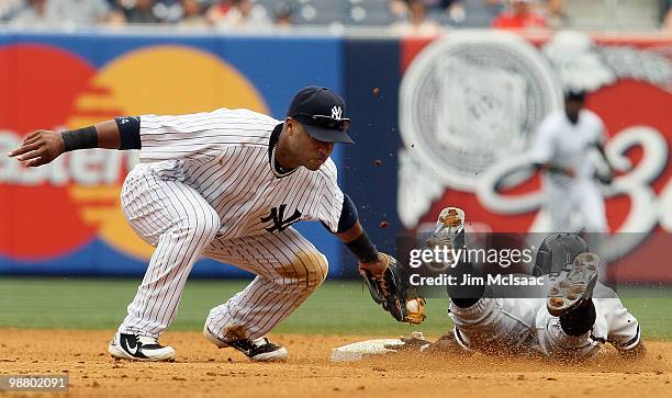 Robinson Cano of the New York Yankees tags out Juan Pierre of the Chicago White Sox in the fifth inning as he attempted to steal second base on May...