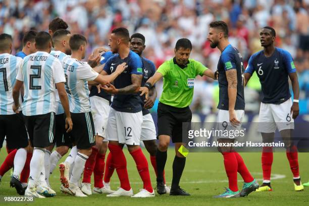 Referee Alireza Faghani looks to separate Argentina and France players as they clash during the 2018 FIFA World Cup Russia Round of 16 match between...