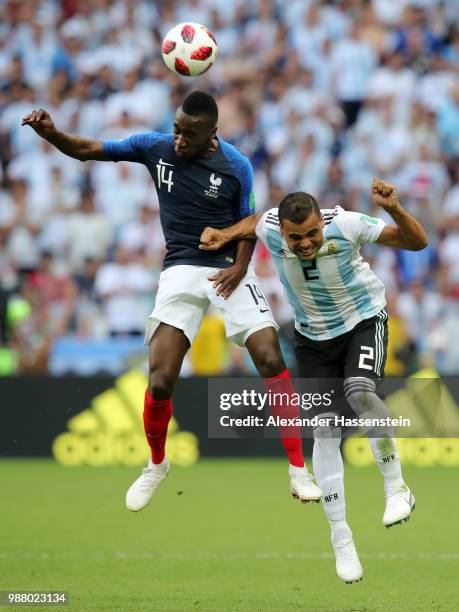 Blaise Matuidi of France and Gabriel Mercado of Argentina battle for the header during the 2018 FIFA World Cup Russia Round of 16 match between...
