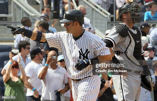 Nick Swisher of the New York Yankees celebrates his sixth inning two run home run as A.J. Pierzynski the Chicago White Sox looks on on May 2, 2010 at...