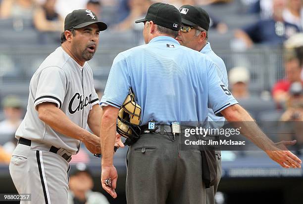Manager Ozzie Guillen of the Chicago White Sox argues with home plate umpire Dan Iassogna and first base umpire Dale Scott after being ejected from...
