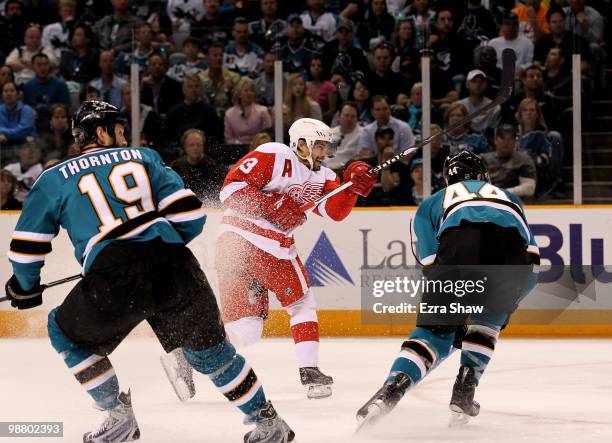 Pavel Datsyuk of the Detroit Red Wings scores a slapshot goal while defended by Marc-Edouard Vlasic and Joe Thornton of the San Jose Sharks in Game...