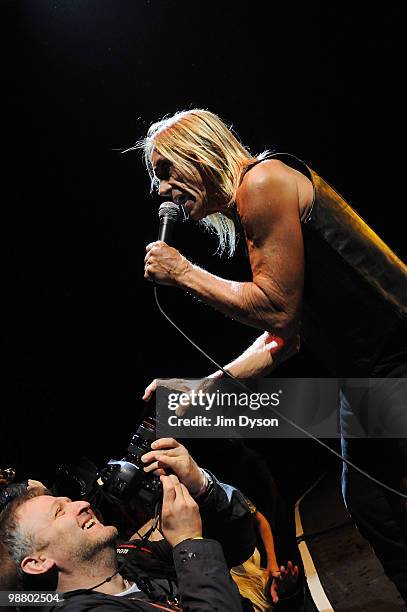 Iggy Pop grabs the camera of photographer Matt Kent as he performs live on stage with The Stooges at Hammersmith Apollo on May 2, 2010 in London,...