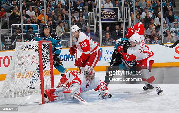 Jimmy Howard, Brad Stuart and Dan Cleary of the Detroit Red Wings defend against Ryane Clowe and Manny Malhotra of the San Jose Sharks in Game Two of...