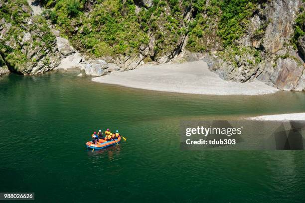 high angle view of a group of men and women heading to or from  shore while rafting - iya valley stock pictures, royalty-free photos & images