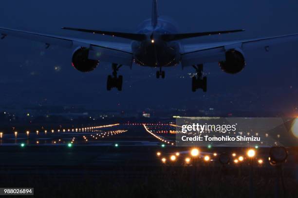 landing towards the beautiful runway induction lamp is shining - runway night stock pictures, royalty-free photos & images