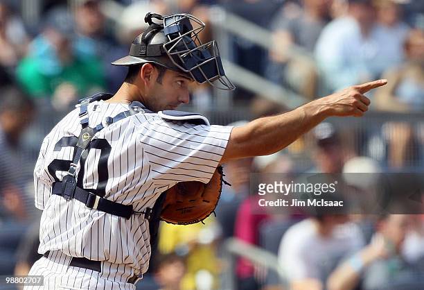 Jorge Posada of the New York Yankees points to teammate pitcher Phil Hughes , after a sixth inning strike out against the Chicago White Sox on May 2,...