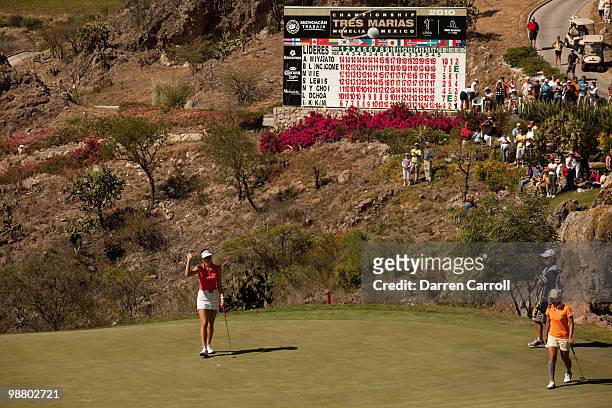 Michelle Wie waves to the crowd on the 18th hole during the fourth round of the Tres Marias Championship at the Tres Marias Country Club on May 2,...