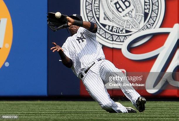Marcus Thames of the New York Yankees makes a sliding catch against the Chicago White Sox for the final out of the second inning on May 2, 2010 at...