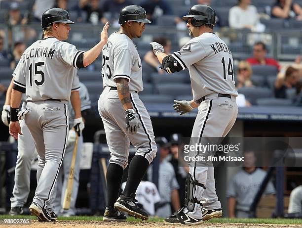 Paul Konerko of the Chicago White Sox celebrates his ninth inning three run home run against the New York Yankees with teammates Andruw Jones and...
