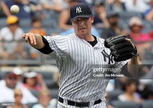 Starting pitcher Phil Hughes of the New York Yankees throws to first base for an out against the Chicago White Sox on May 2, 2010 at Yankee Stadium...