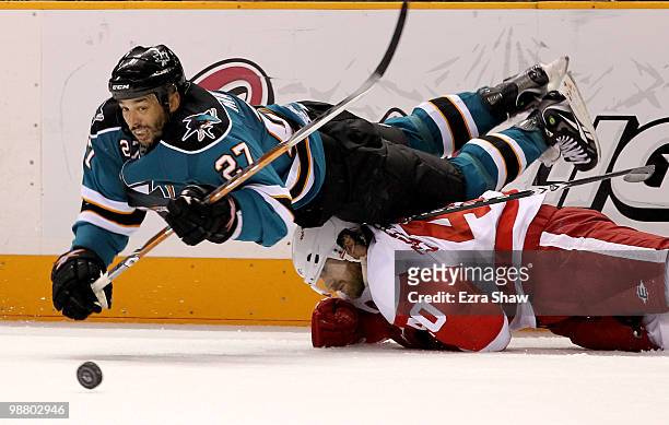 Manny Malhotra of the San Jose Sharks dives over Henrik Zetterberg of the Detroit Red Wings in Game Two of the Western Conference Semifinals during...