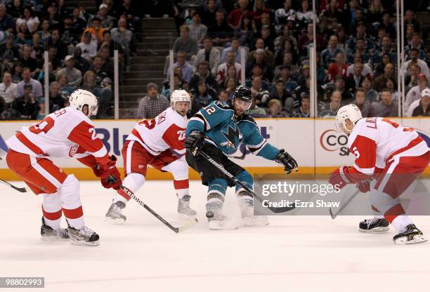 Patrick Marleau of the San Jose Sharks is surrounded by Drew Miller, Brian Rafalski and Nicklas Lidstrom of the Detroit Red Wings in Game Two of the...