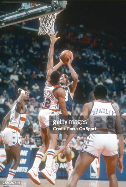 Clark Kellogg of the Indiana Pacers shoots over Greg Ballard of the Washington Bullets during an NBA basketball game circa 1984 at the Capital Centre...
