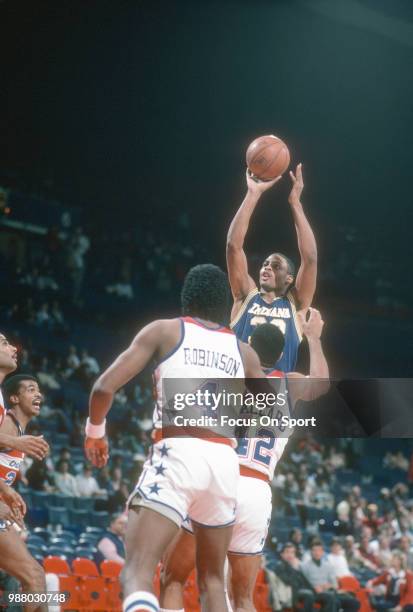 Clark Kellogg of the Indiana Pacers shoots over Greg Ballard of the Washington Bullets during an NBA basketball game circa 1984 at the Capital Centre...