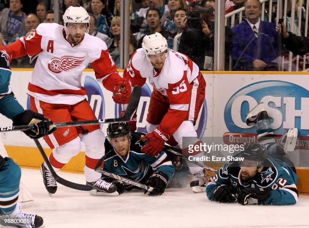Joe Pavelski and Dan Boyle of the San Jose Sharks hit the ice after colliding with Pavel Datsyuk and Niklas Kronwall of the Detroit Red Wings in Game...