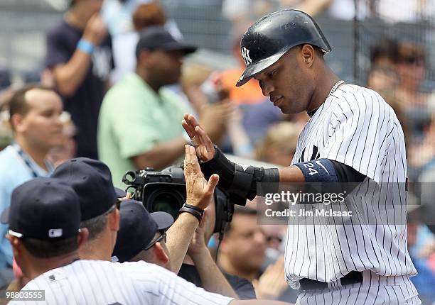 Robinson Cano of the New York Yankees celebrates scoring a run in the second inning against the Chicago White Sox on May 2, 2010 at Yankee Stadium in...