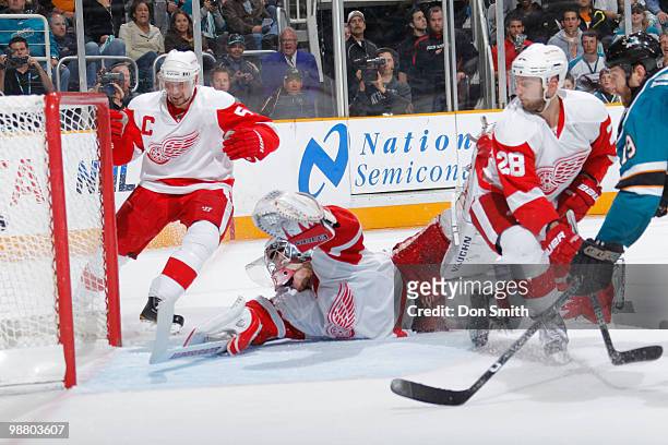Nicklas Lidstrom, Brian Rafalski and Jimmy Howard of the Detroit Red Wings watch Joe Thornton of the San Jose Sharks score the game winning goal in...