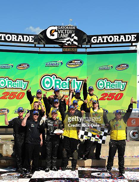 Johnny Sauter driver of the In Country TV Chevrolet and his crew celebrate in victory lane after winning the NASCAR Camping World Truck Series...