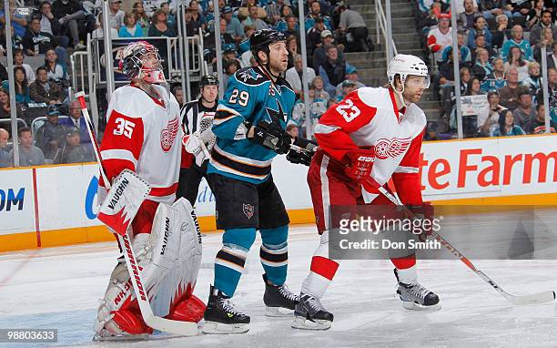 Jimmy Howard and Brad Stuart of the Detroit Red Wings battle Ryane Clowe of the San Jose Sharks in Game Two of the Western Conference Semifinals...