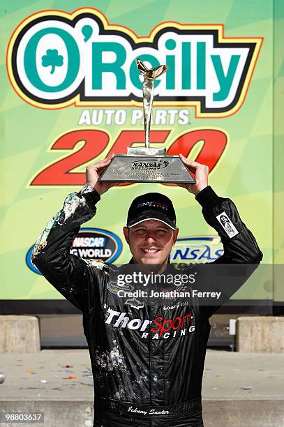 Johnny Sauter driver of the In Country Television Chevrolet celebrates winning the NASCAR Camping World Truck Series O'Reilly Auto Parts 250 on May...