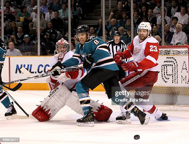 Joe Pavelski of the San Jose Sharks is defended by Brad Stuart and goalie Jimmy Howard of the Detroit Red Wings in Game Two of the Western Conference...