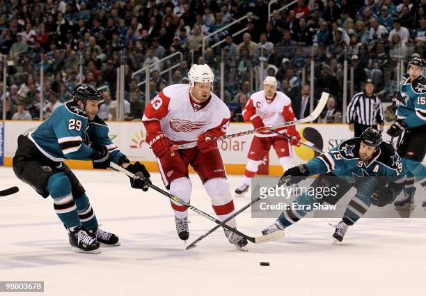 Ryane Clowe and Joe Thornton of the San Jose Sharks try to stop Johan Franzen of the Detroit Red Wings in Game Two of the Western Conference...