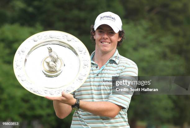 Rory McIlroy of Northern Ireland poses with the winner's trophy after his four-stroke victory at the 2010 Quail Hollow Championship at the Quail...