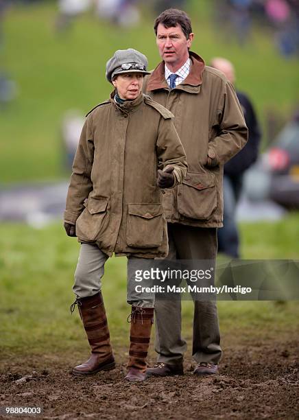 Princess Anne, Princess Royal and husband Vice-Admiral Tim Laurence stand in a muddy field as they attend the Badminton Horse Trials, in which...
