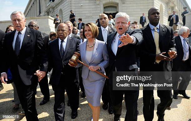 Speaker of the House Nancy Pelosi surrounded by leadership, and arm and arm with Congressman John Lewis , as they walked to the Capitol building, on...