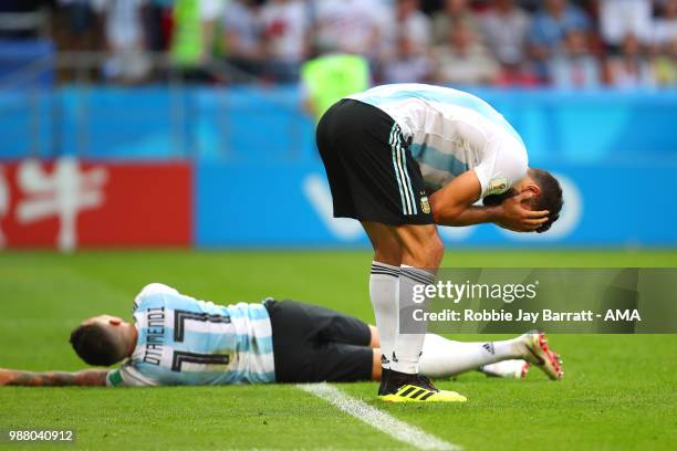 Lucas Biglia of Argentina and Nicolas Otamendi of Argentina look dejected at the end of the 2018 FIFA World Cup Russia Round of 16 match between...