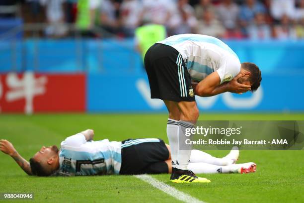 Lucas Biglia of Argentina and Nicolas Otamendi of Argentina look dejected at the end of the 2018 FIFA World Cup Russia Round of 16 match between...