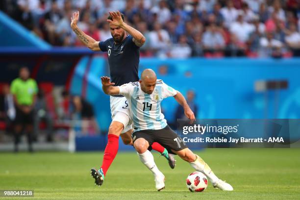 Javier Mascherano of Argentina competes with Olivier Grioud of France during the 2018 FIFA World Cup Russia Round of 16 match between France and...