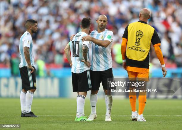 Javier Mascherano embraces team mate Lionel Messi of Argentina following during the 2018 FIFA World Cup Russia Round of 16 match between France and...