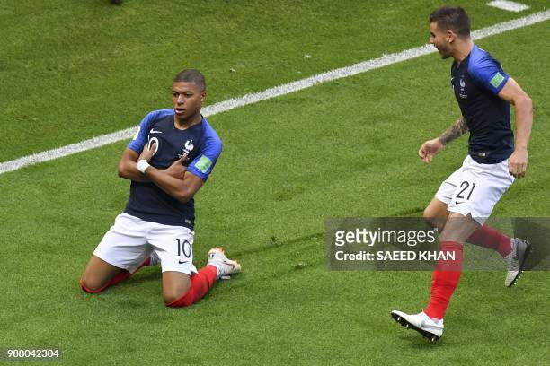 France's forward Kylian Mbappe celebrates after scoring his team's third goal during the Russia 2018 World Cup round of 16 football match between...