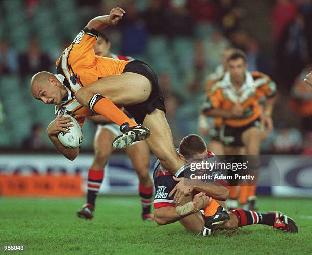 Tyran Smith of Wests Tigers is tackled by Bryan Fletcher of the Sydney Roosters during Round 14 of the National Rugby League played at the Sydney...