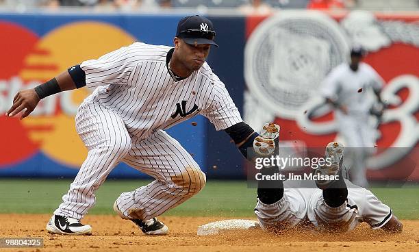 Robinson Cano of the New York Yankees tags out Juan Pierre of the Chicago White Sox in the fifth inning as he attempted to steal second base on May...
