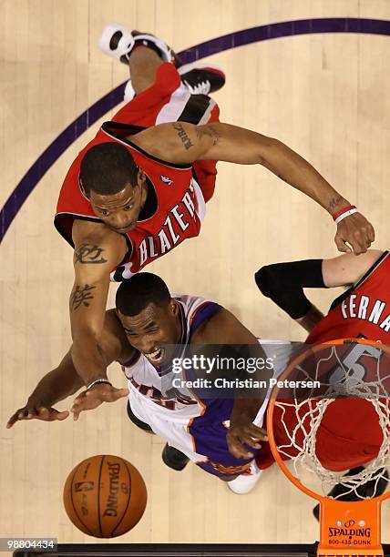 Marcus Camby of the Portland Trail Blazers and Jarron Collins of the Phoenix Suns battle for a rebound during Game One of the Western Conference...