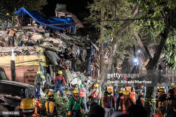 Rescuers, volunteers and firefighters work after the magnitude 7.1 earthquake that jolted central Mexico damaging buildings, knocking out power and...