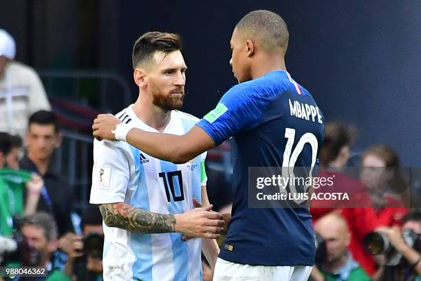 Argentina's forward Lionel Messi congratulates France's forward Kylian Mbappe at the end of the Russia 2018 World Cup round of 16 football match...