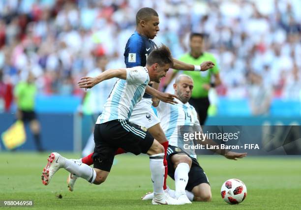 Kylian Mbappe of France is challenged by Nicolas Tagliafico of Argentina and Javier Mascherano of Argentina during the 2018 FIFA World Cup Russia...