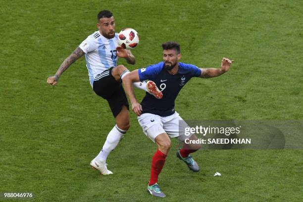 Argentina's defender Nicolas Otamendi vies for the ball with France's forward Olivier Giroud during the Russia 2018 World Cup round of 16 football...