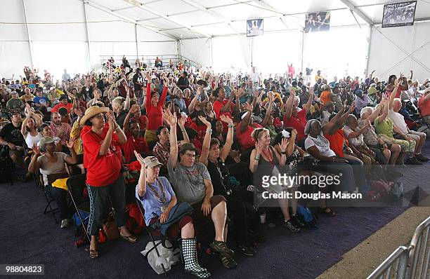 The gospel tent crowd lifts their hands in praise at the 2010 New Orleans Jazz & Heritage Festival Presented By Shell, at the Fair Grounds Race...