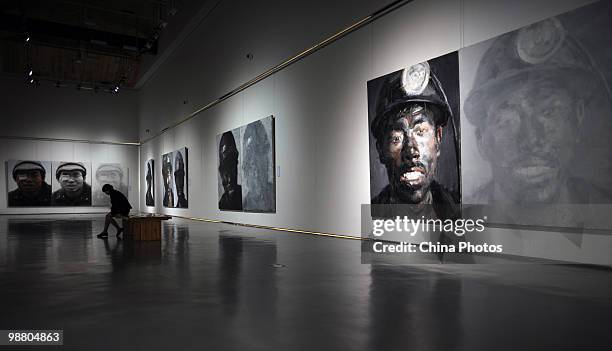 Visitors view artworks at the 'Figures - Xu Weixin Painting Art Exhibition' at the Wuhan Art Museum on May 2, 2010 in Wuhan of Hubei Province, China....