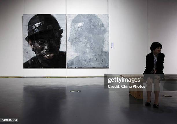 Visitors view artworks at the 'Figures - Xu Weixin Painting Art Exhibition' at the Wuhan Art Museum on May 2, 2010 in Wuhan of Hubei Province, China....