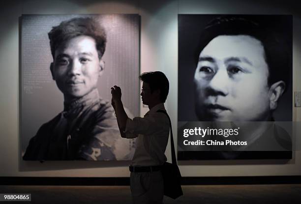 Visitors view artworks at the 'Figures - Xu Weixin Painting Art Exhibition' at the Wuhan Art Museum on May 2, 2010 in Wuhan of Hubei Province, China....